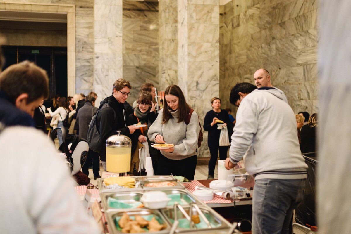 People holding plates of dumplings