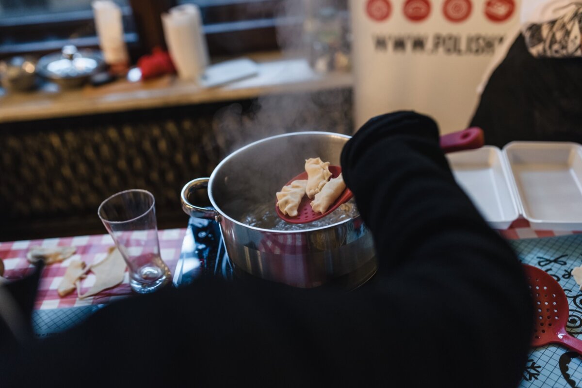 Taking dumplings out of a pot of hot water