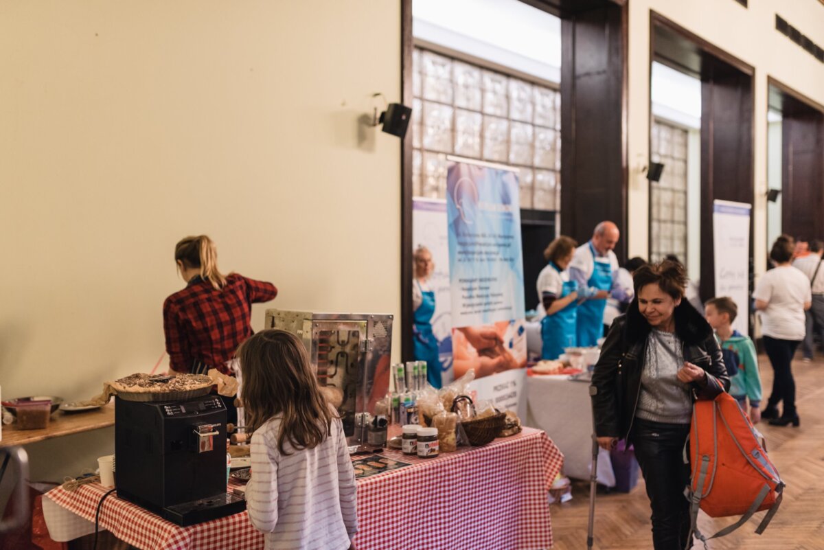 A child watches a cake standing on a coffee machine