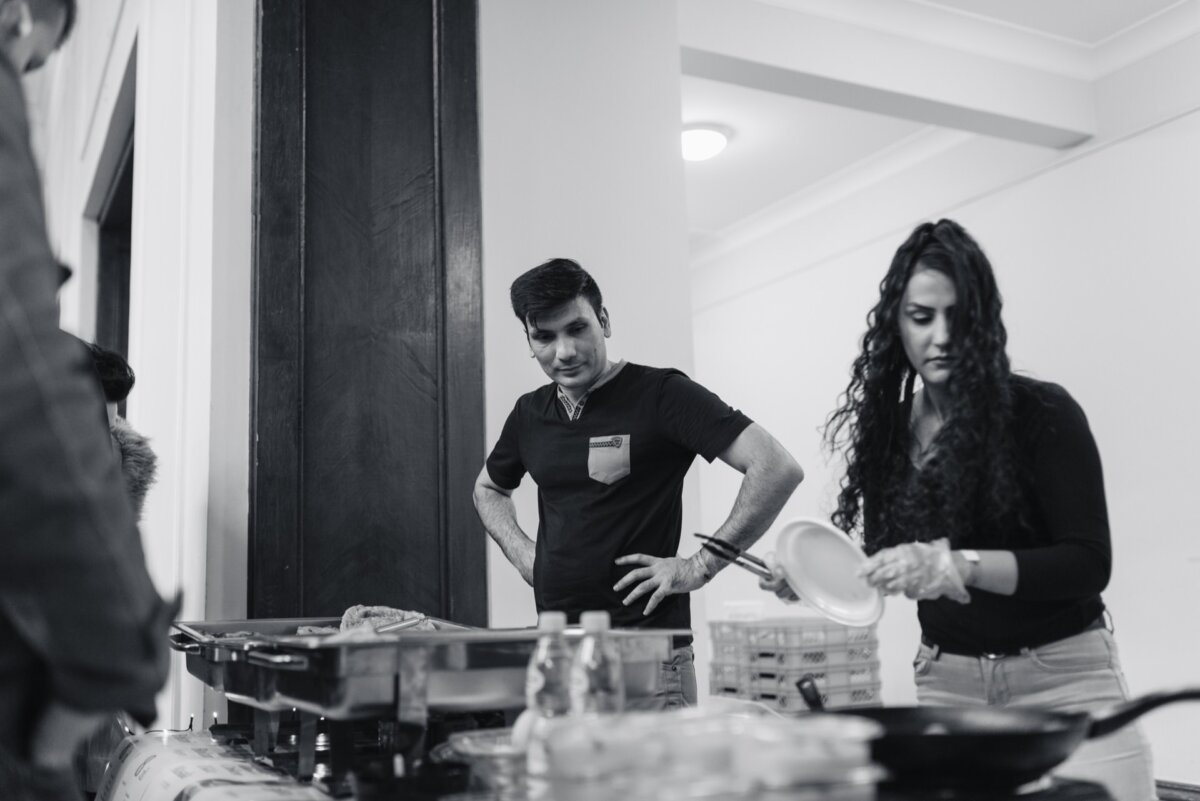 Man watches woman serve dishes