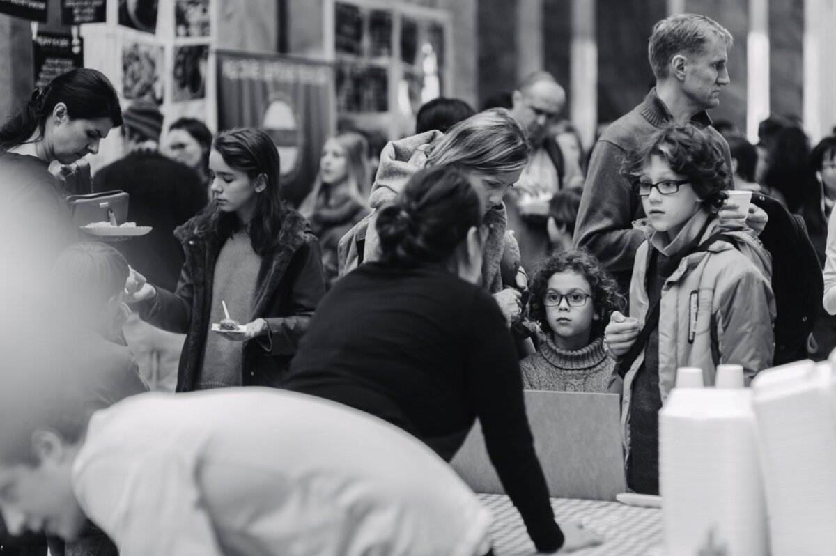 Children look at the woman at the booth