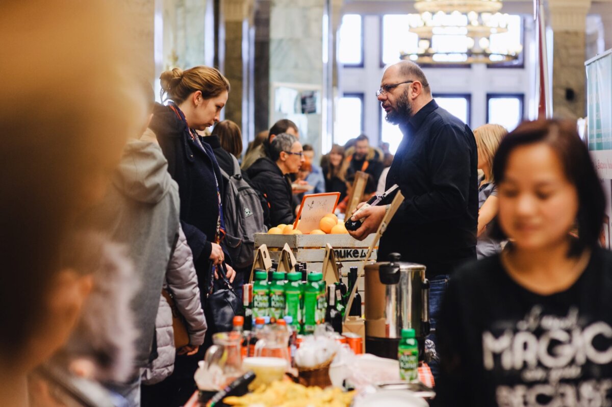 Food, drink and fruit stalls full of people