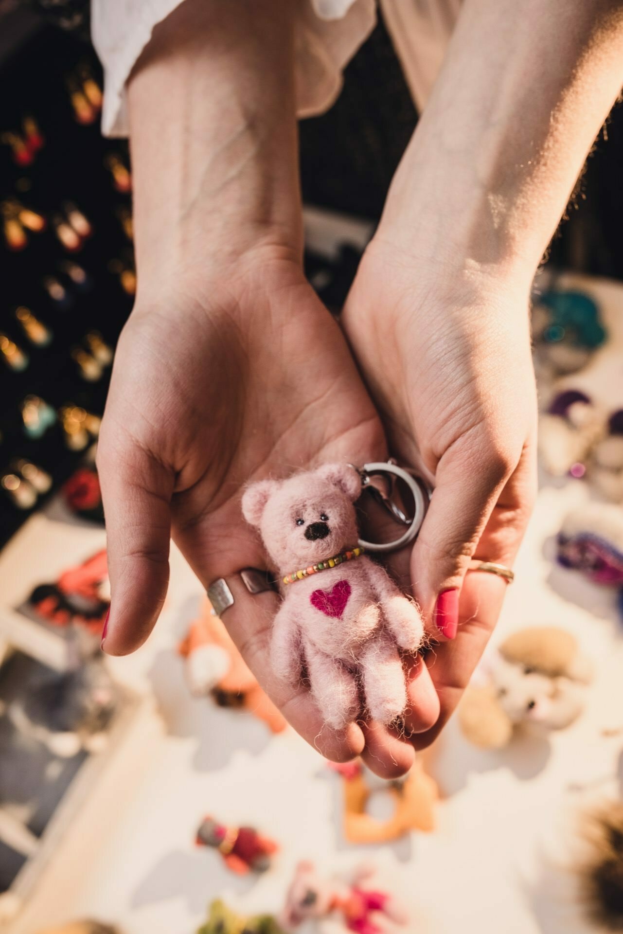 Plush teddy bear with heart held in hands