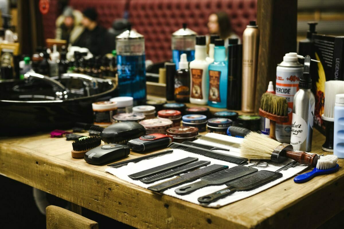 Combs and razors on a wooden table in a barber shop