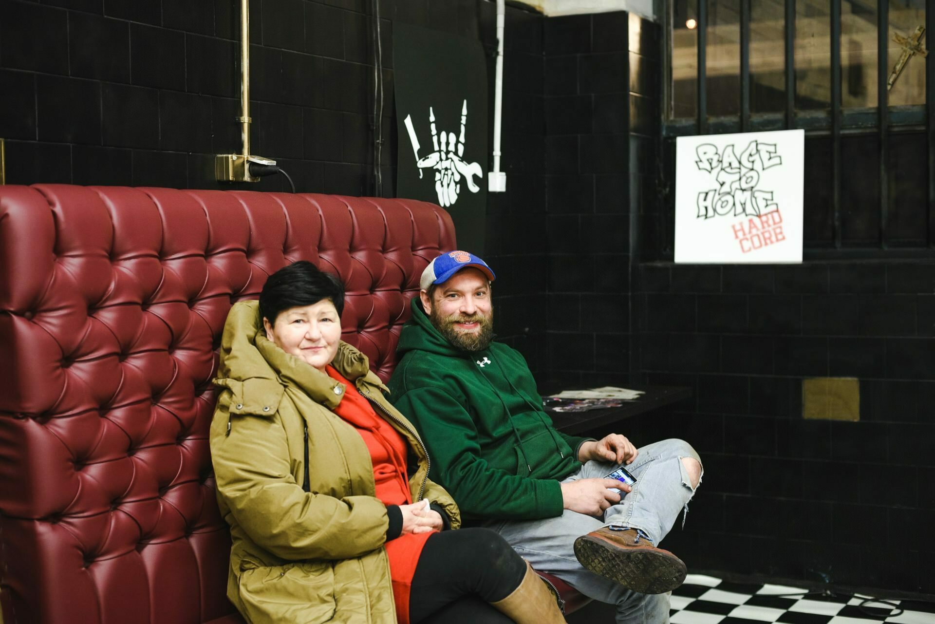 Man and woman on a red leather couch