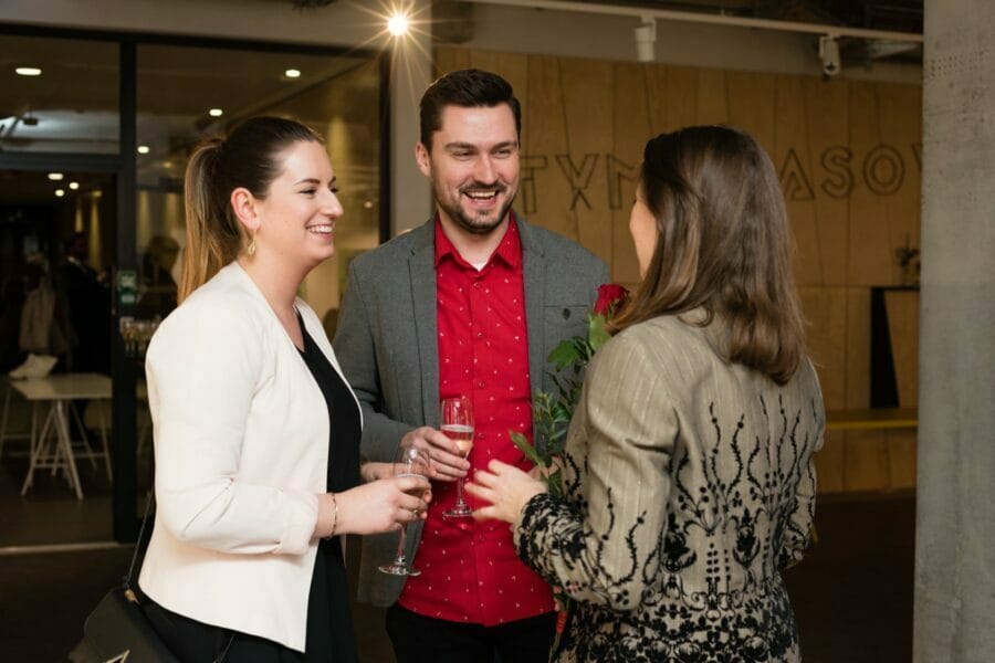 Smiling people with glasses of wine