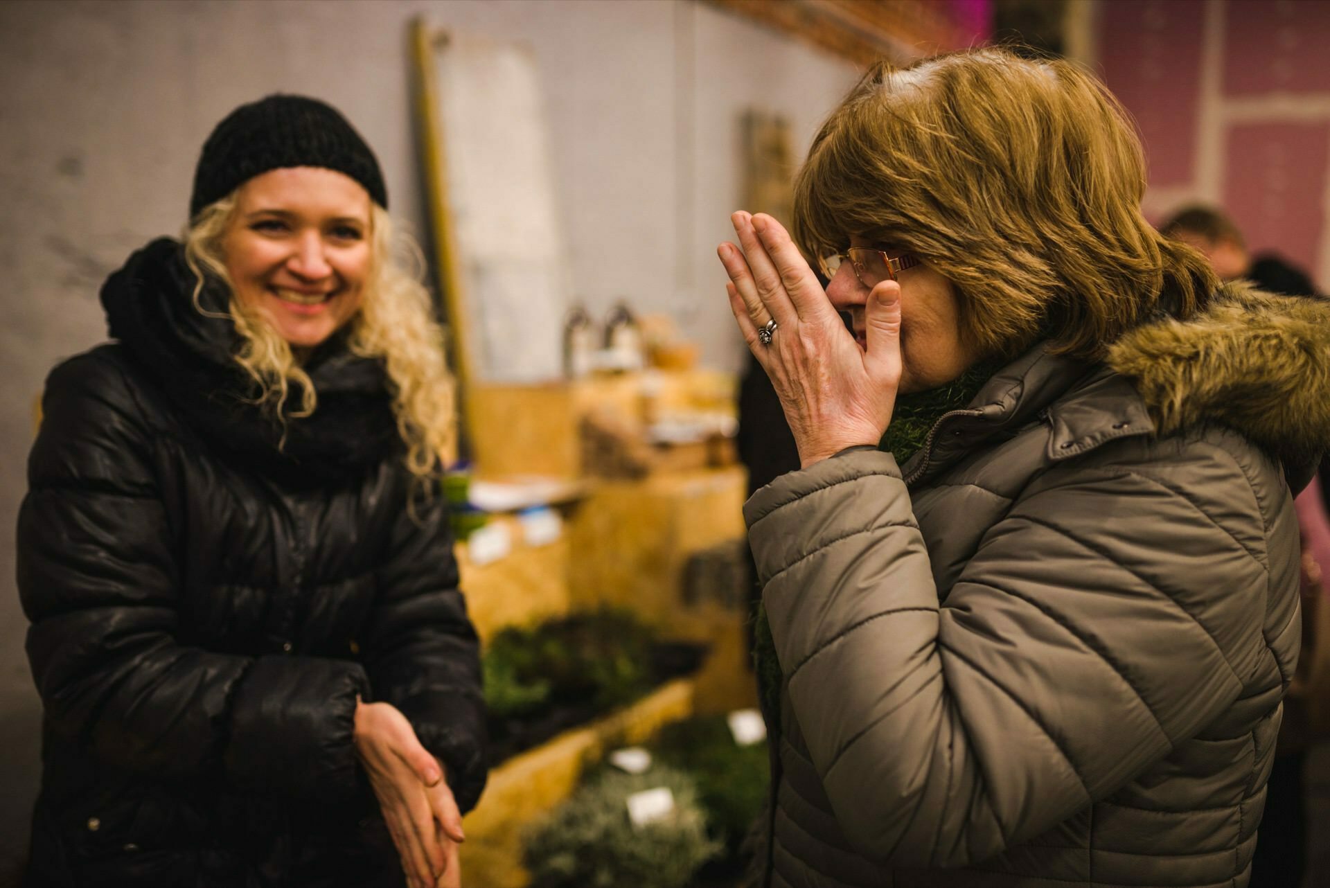 A woman sniffs her palm