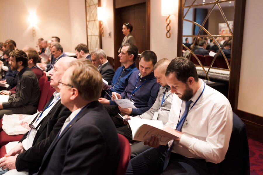 Conference participants browse through catalogs