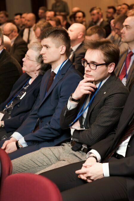 Conference participant scratches his beard