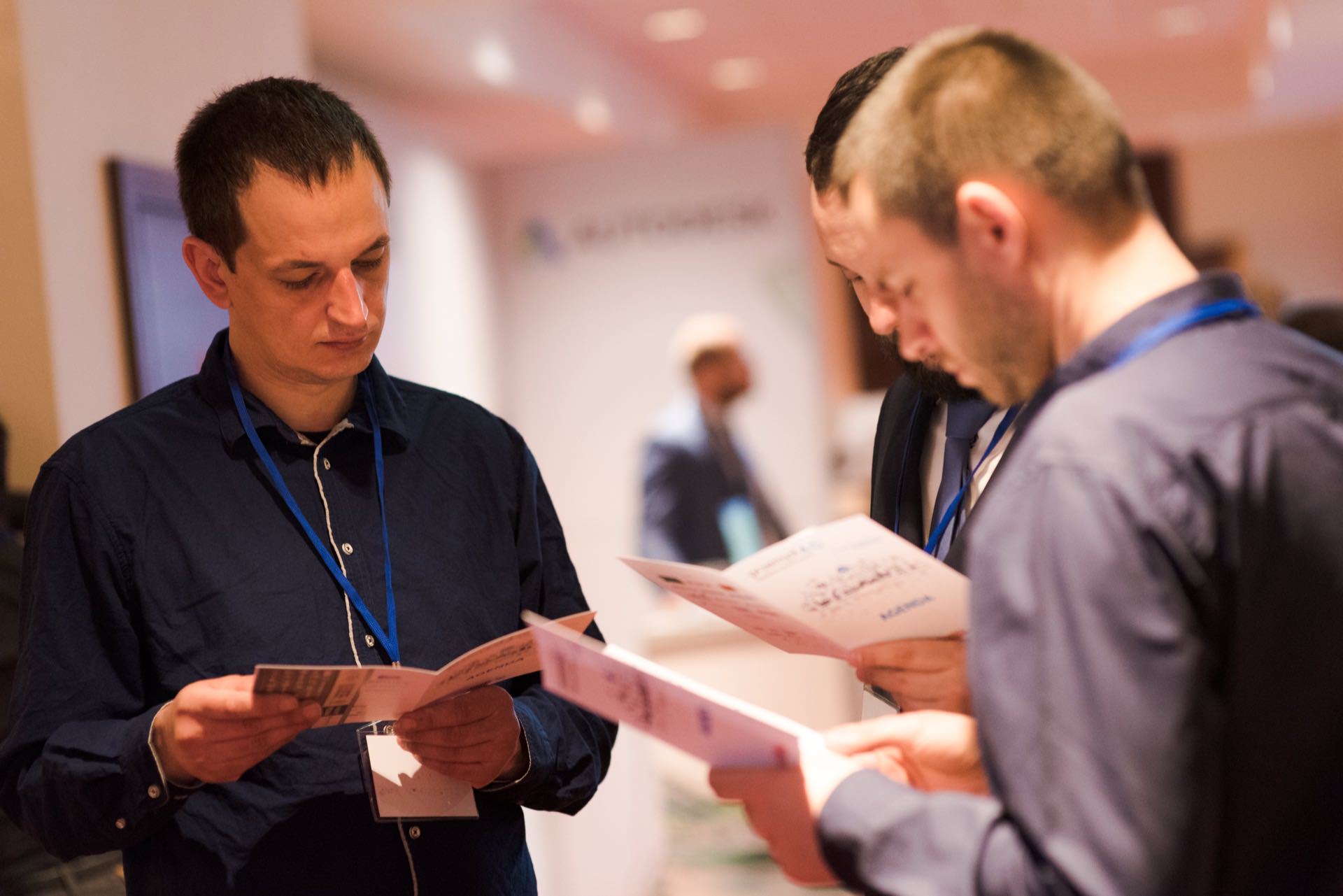 Men browse through catalogs at conference