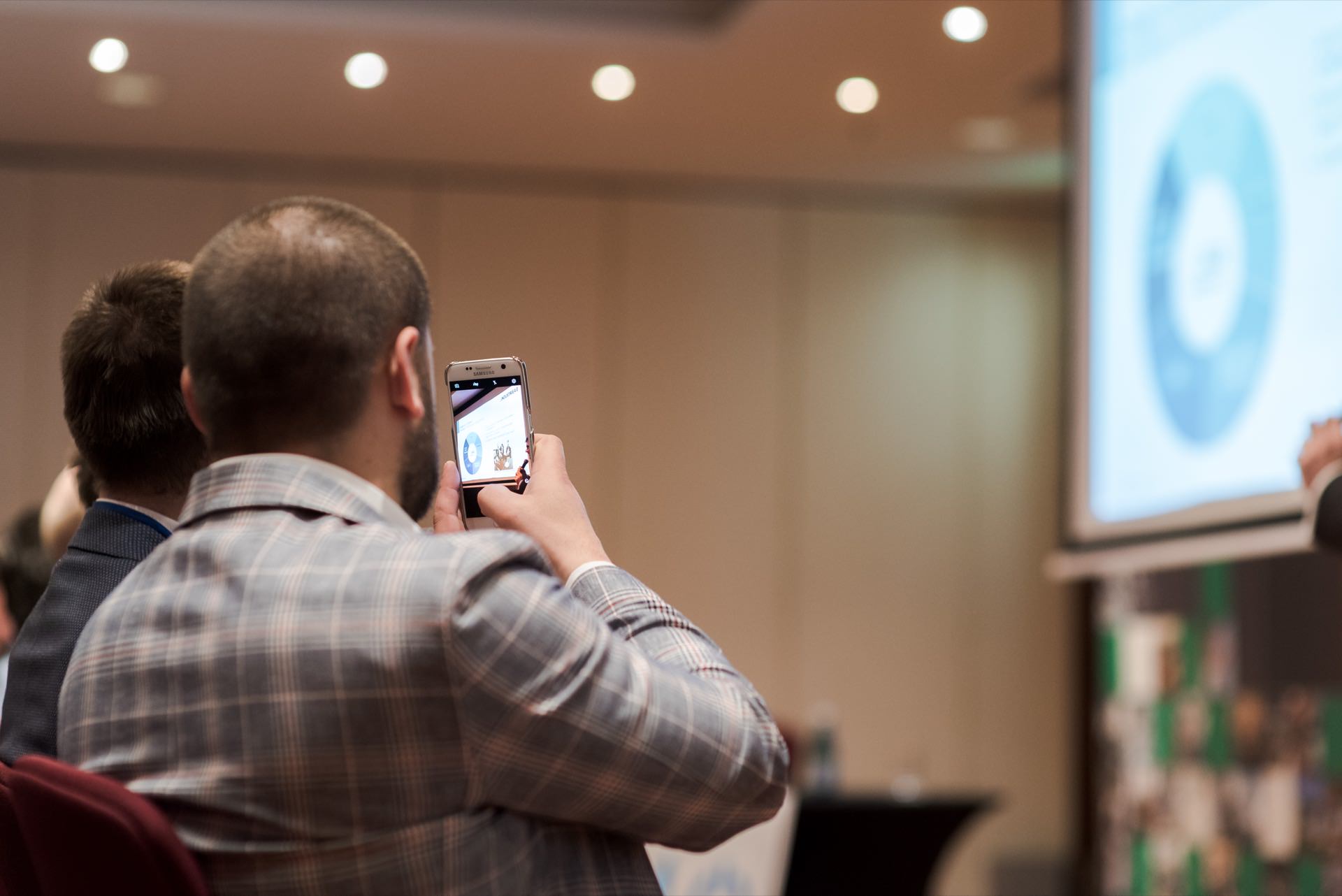 A man takes a picture of the screen