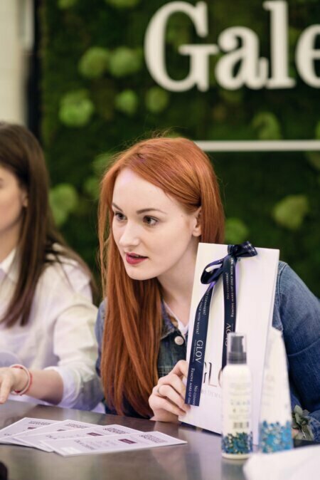 Redheaded girl holds a gift bag