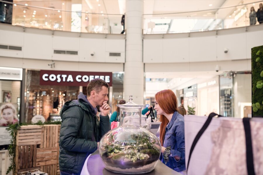 Red-haired girl talks to man in down jacket