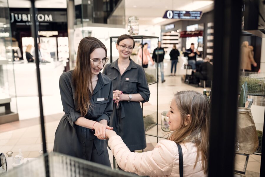 girl with glasses massages woman's hand