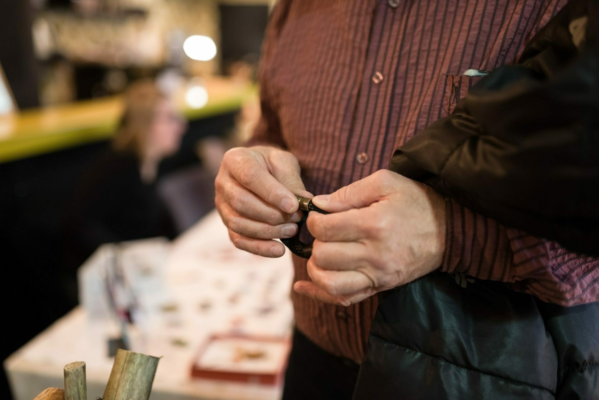 A man holding a bracelet