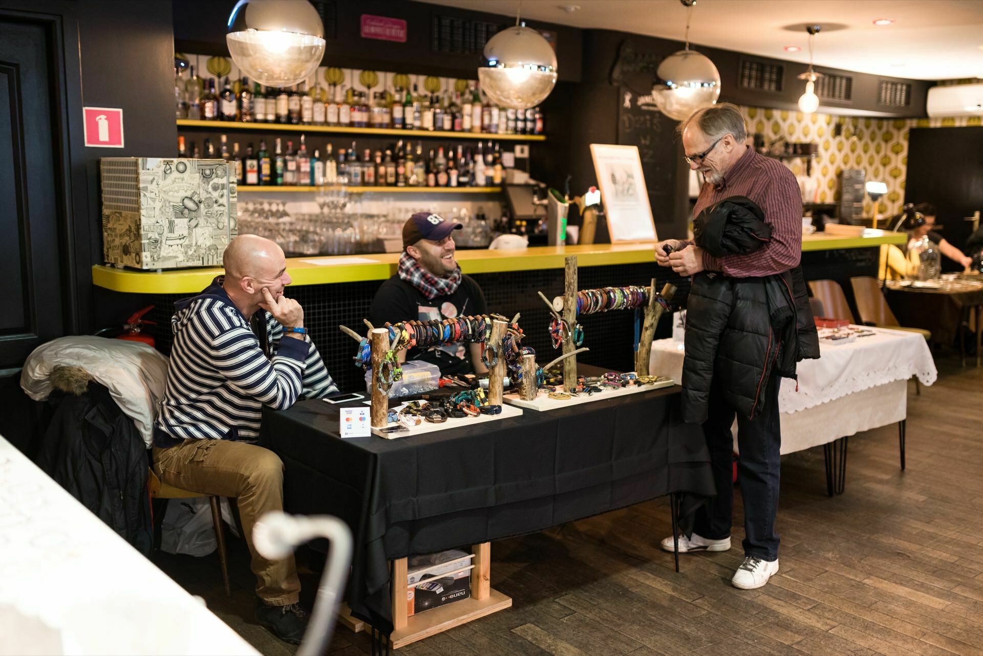 A man looks at bracelets made of ropes