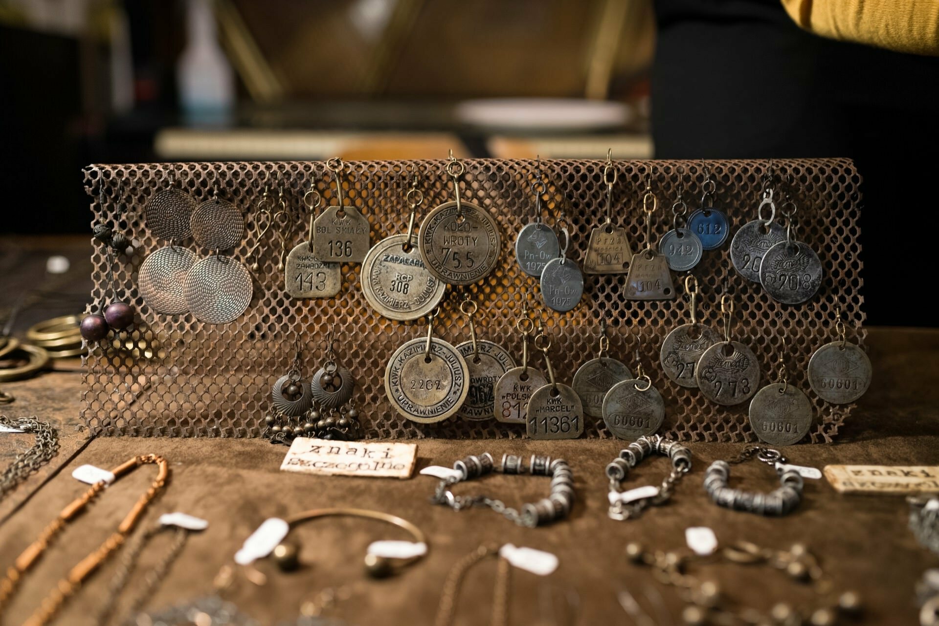 Metal pendants suspended from a metal mesh