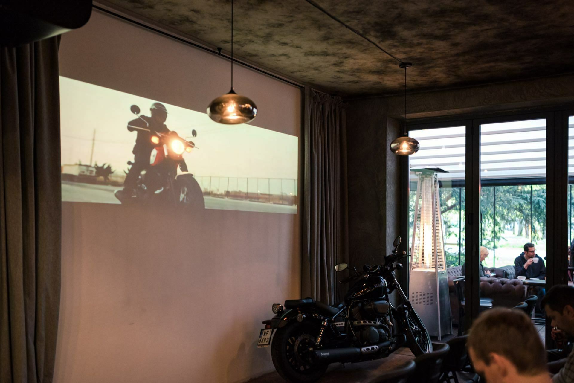 Motorcycle on screen and against the wall