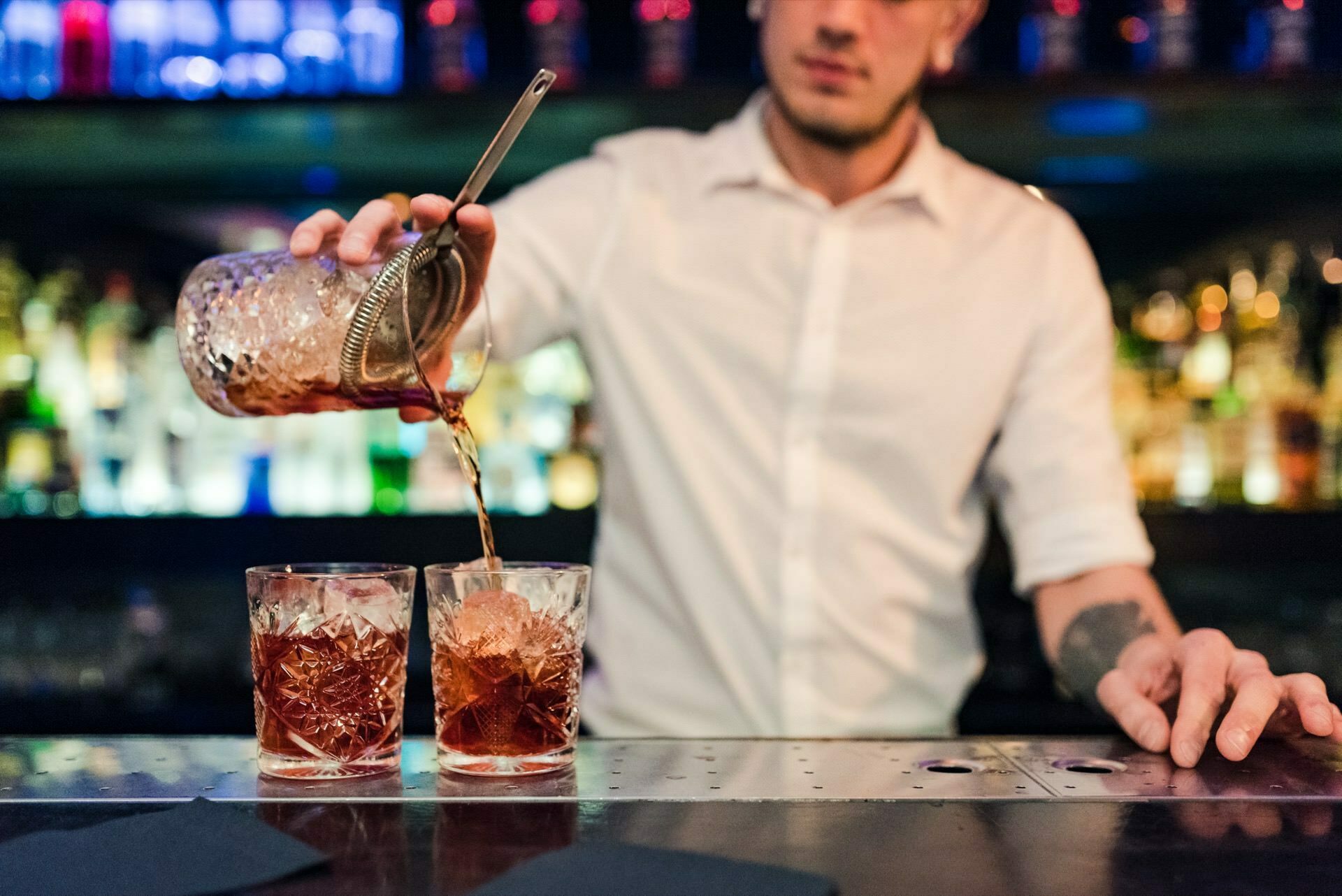 bartender pours drinks with ice