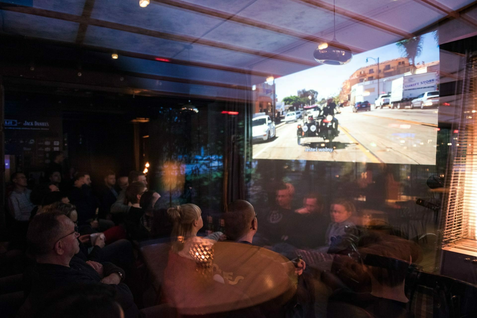 Three-wheeled motorcycle on screen during film screening