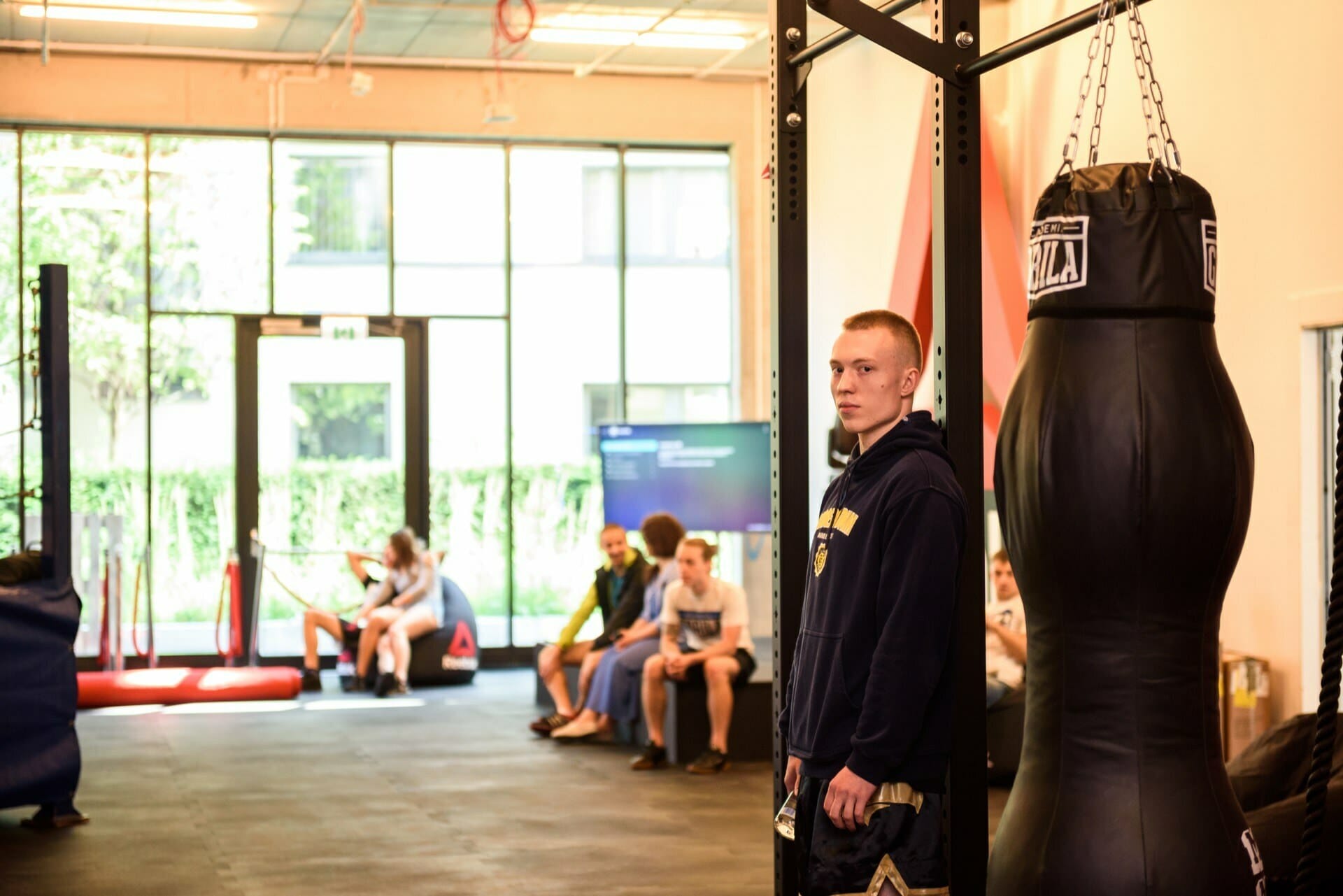 A boy next to a punching bag