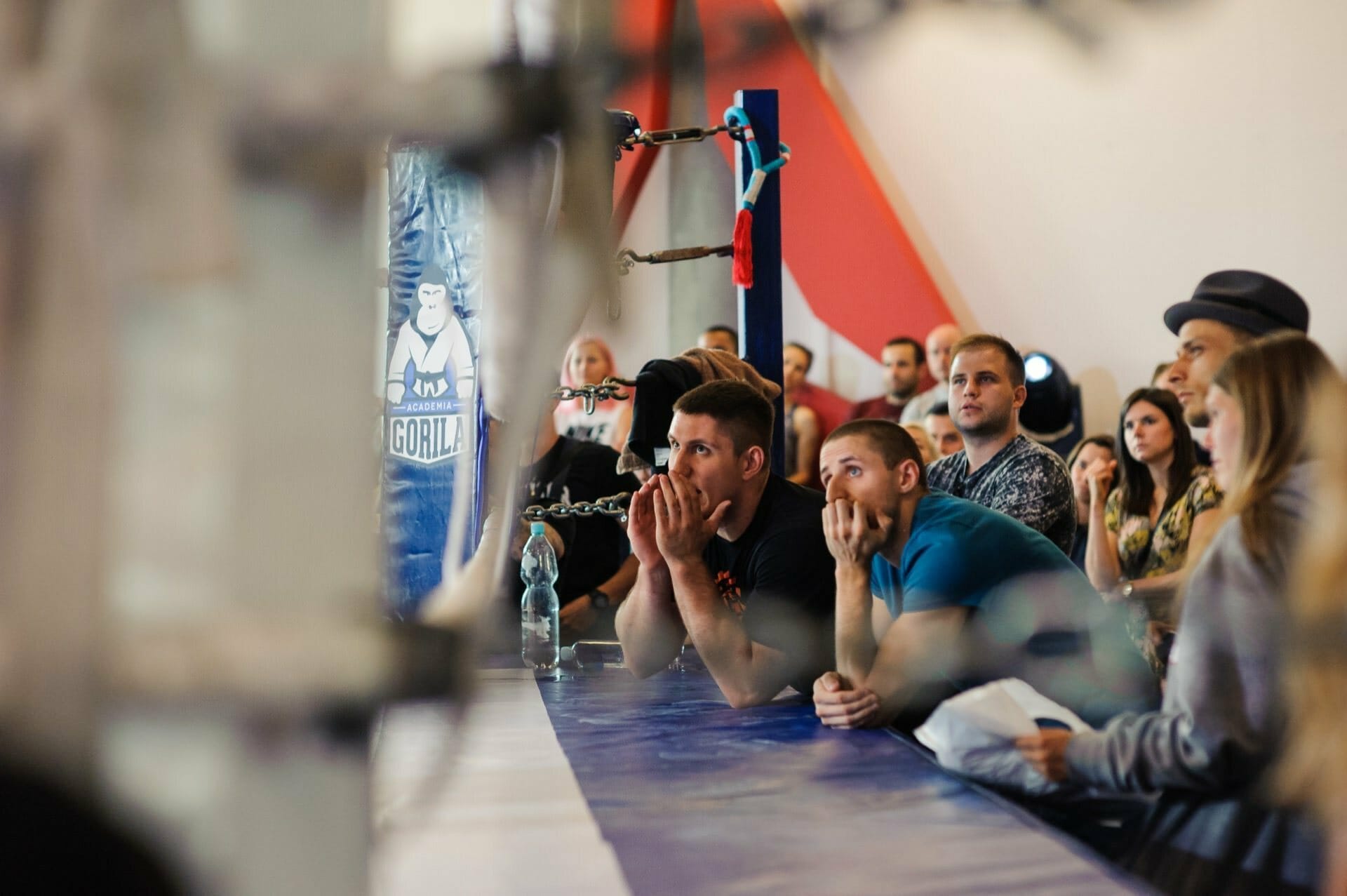 The audience watches the fight in the ring