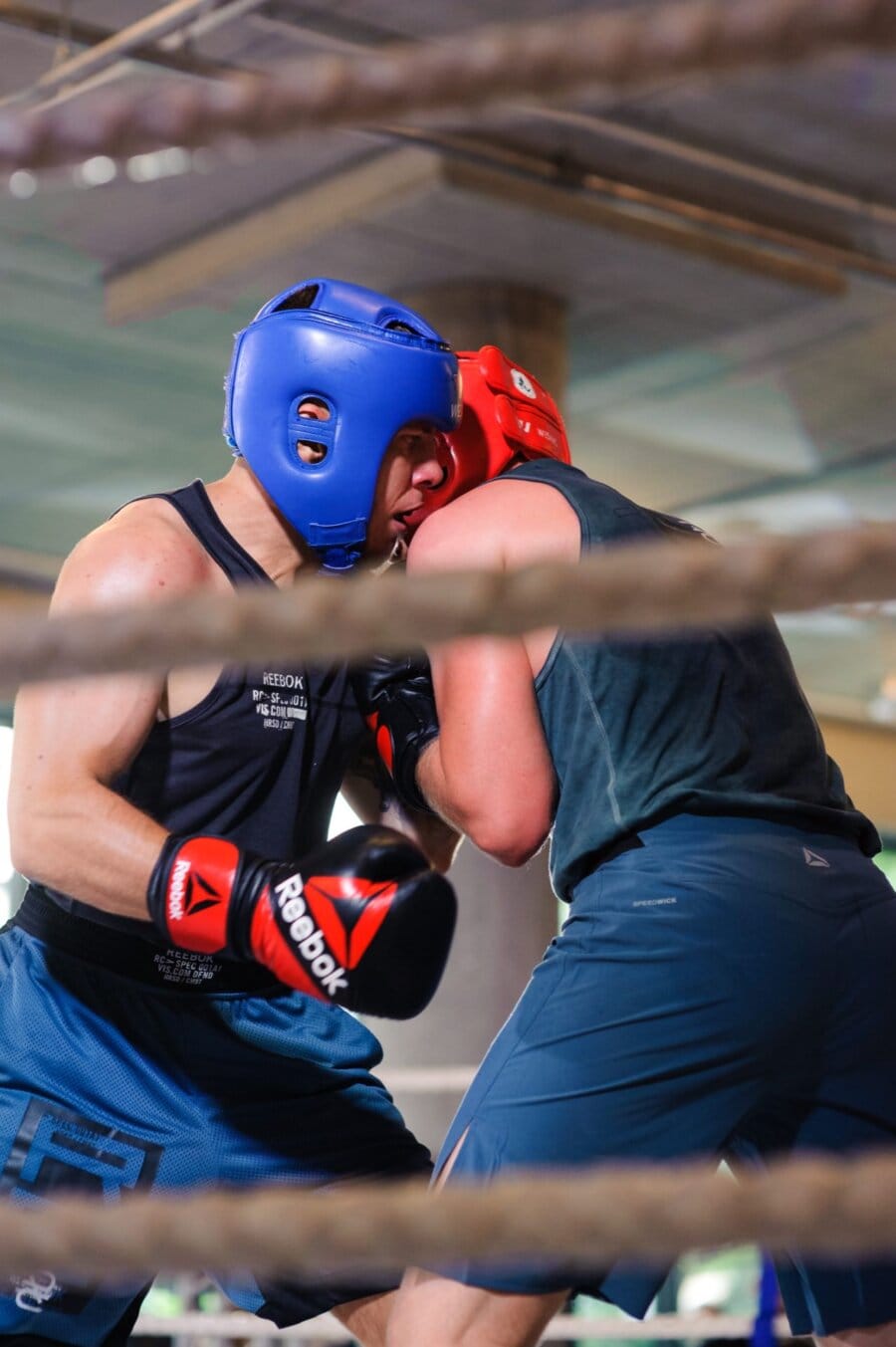 Two fighters in the ring wearing Reebok gloves