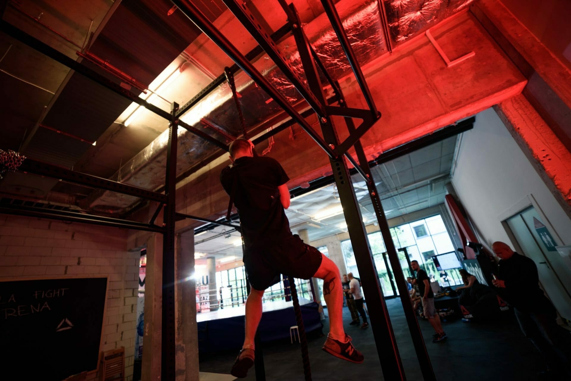 A man pulls himself up on a rope