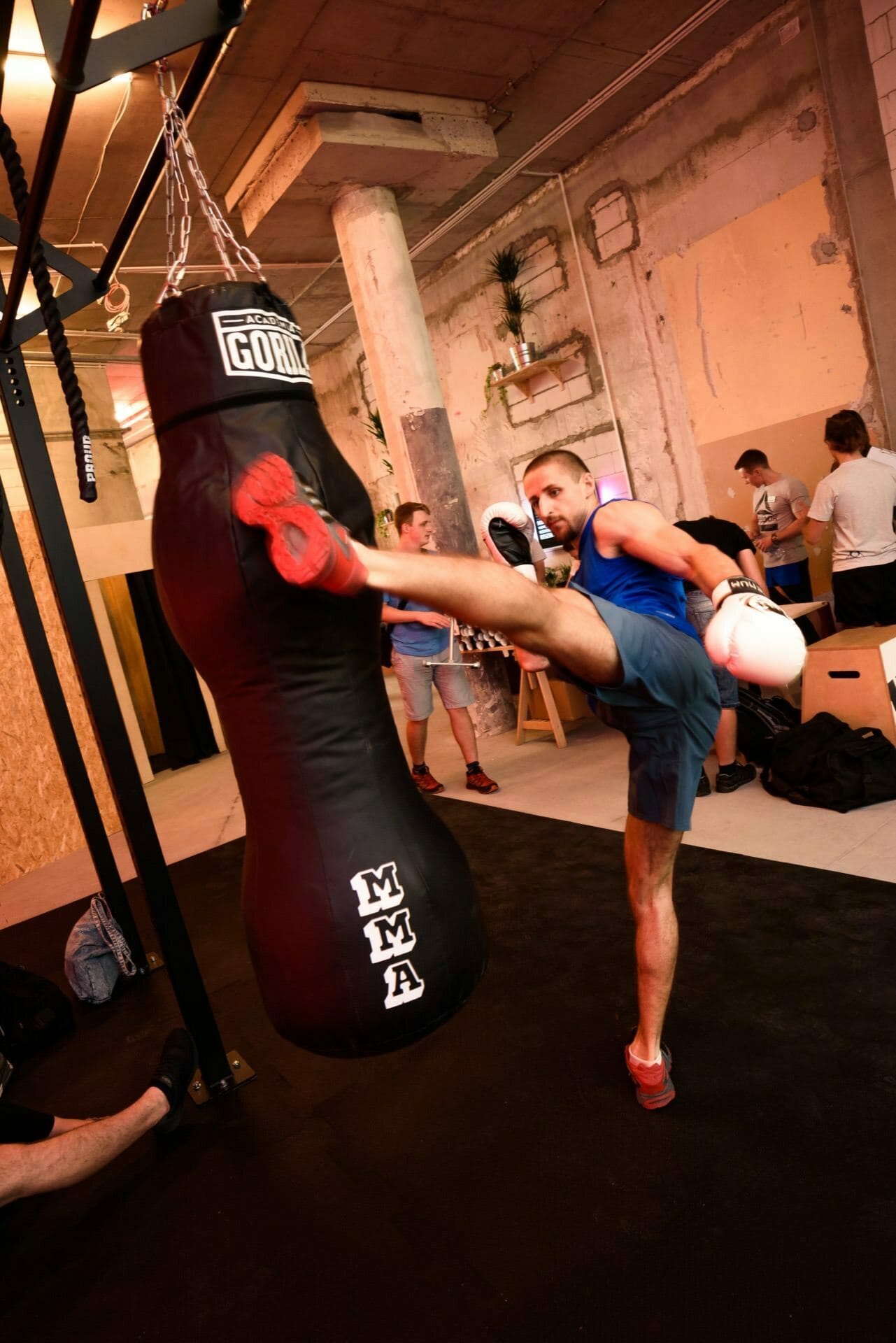 A fighter practices kicks on a Gorila MMA punching bag