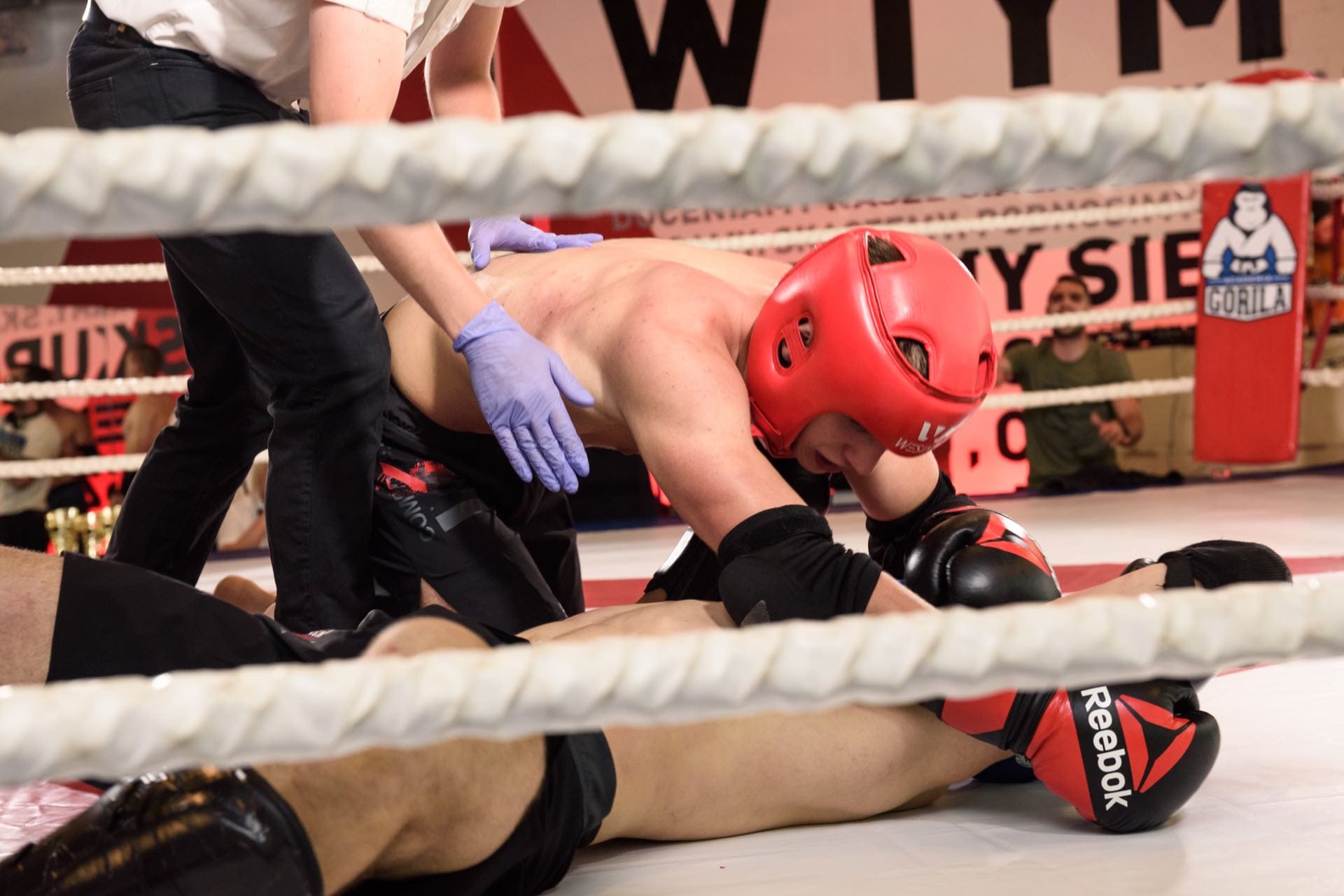 Competitors lying in the ring