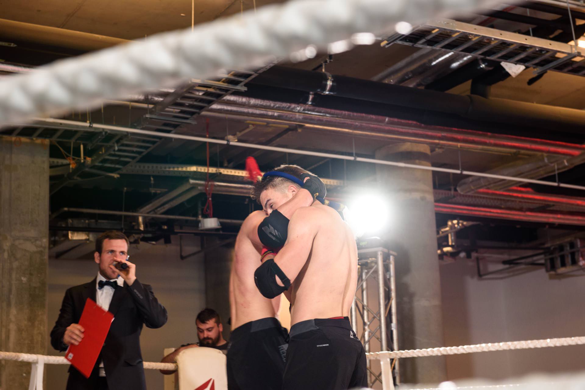 Competitors hug each other in the ring