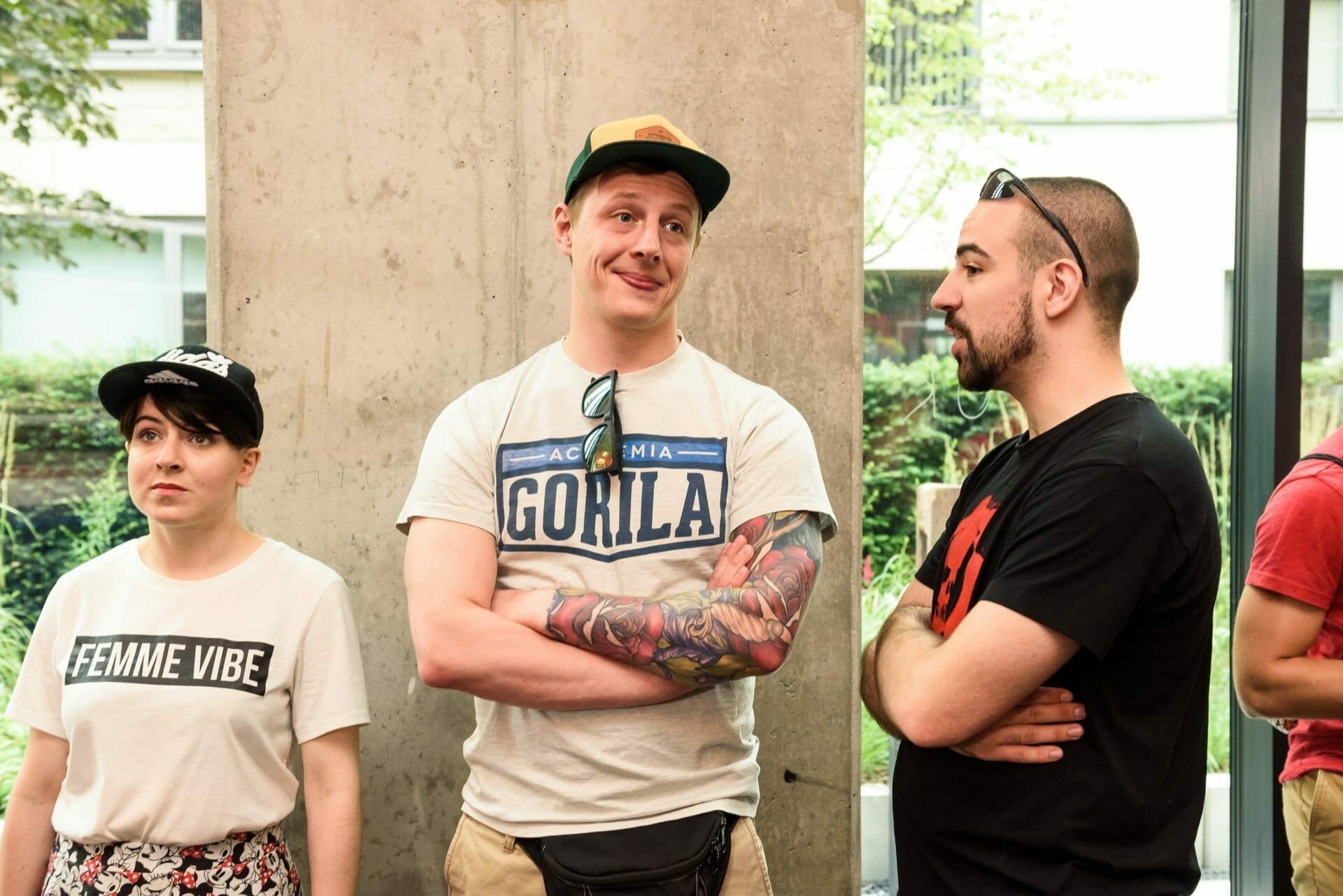 Smiling boy with cap and tattoo in white Academia Gorila T-shirt