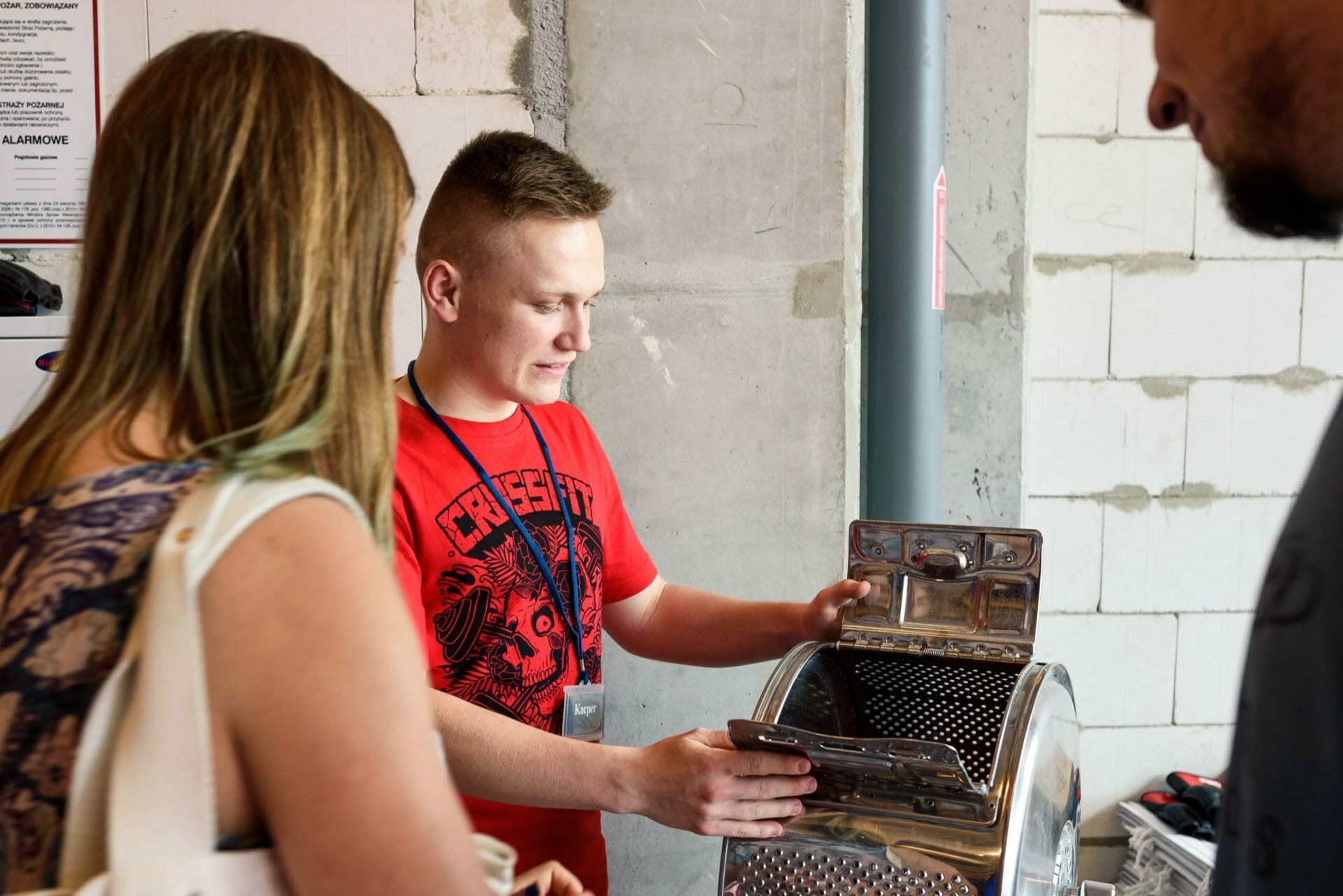 Boy in red crossfit shirt draws task from drum