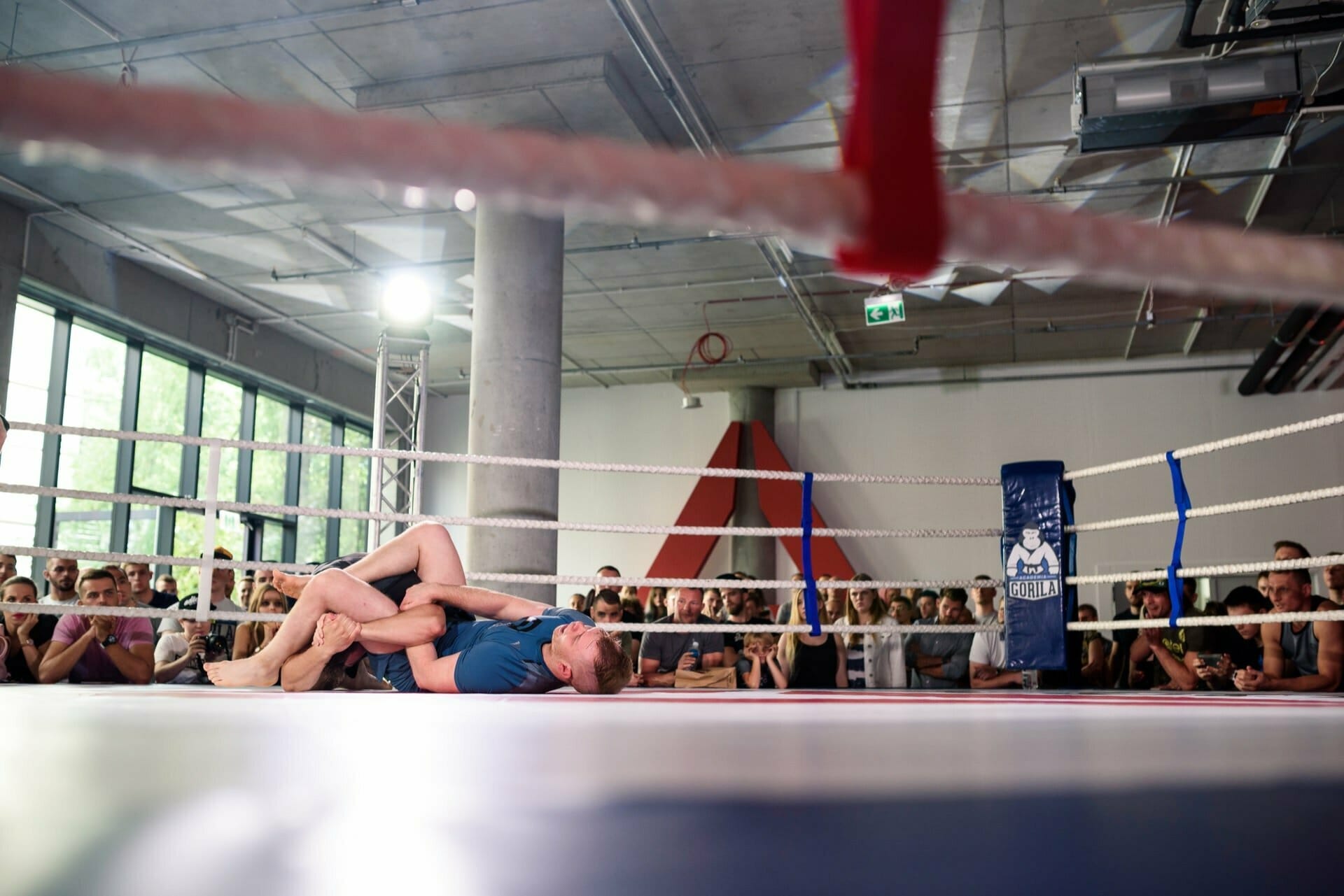 A competitor applies leverage to an opponent on the mat