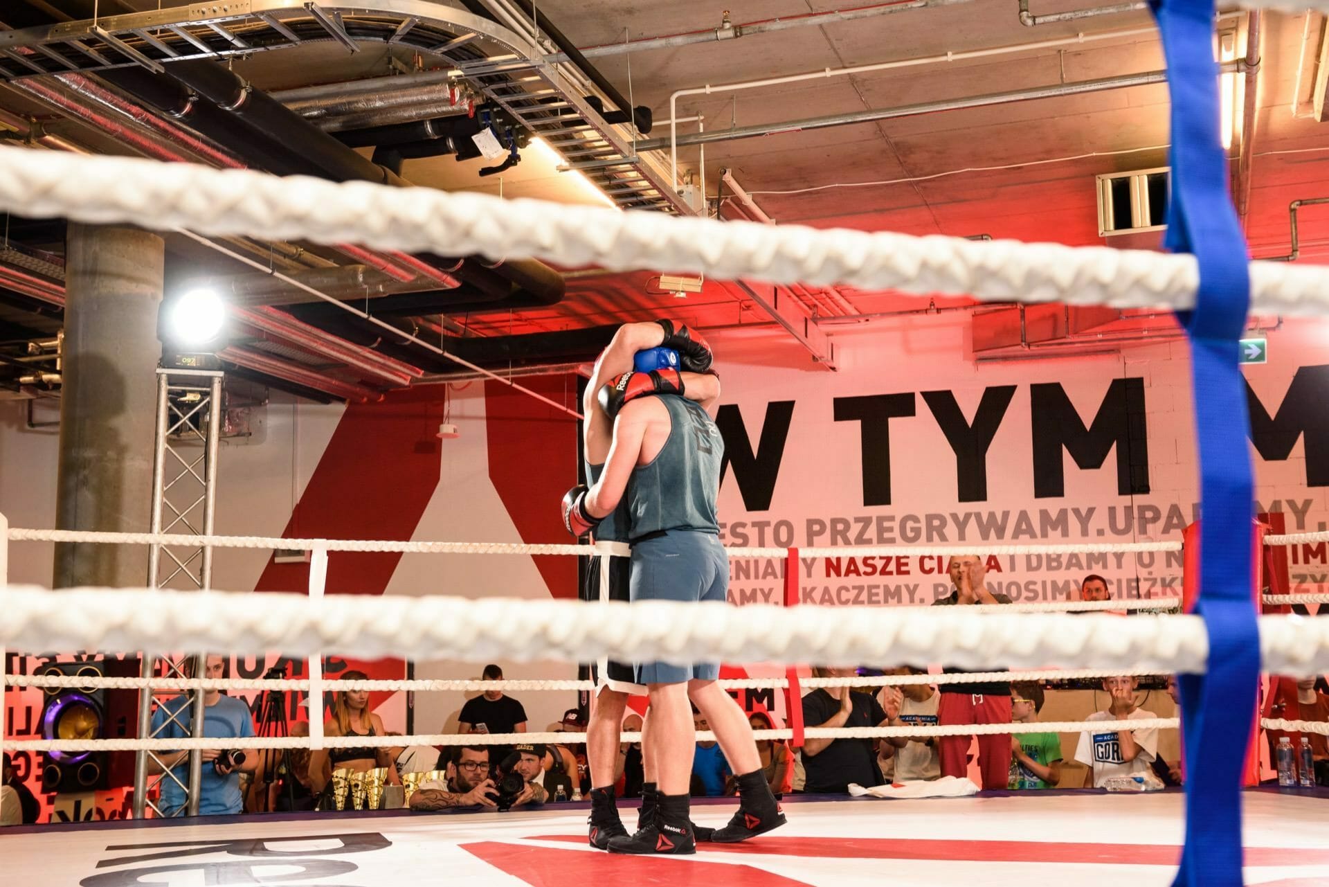 Embrace standing fighters in the ring before the fight