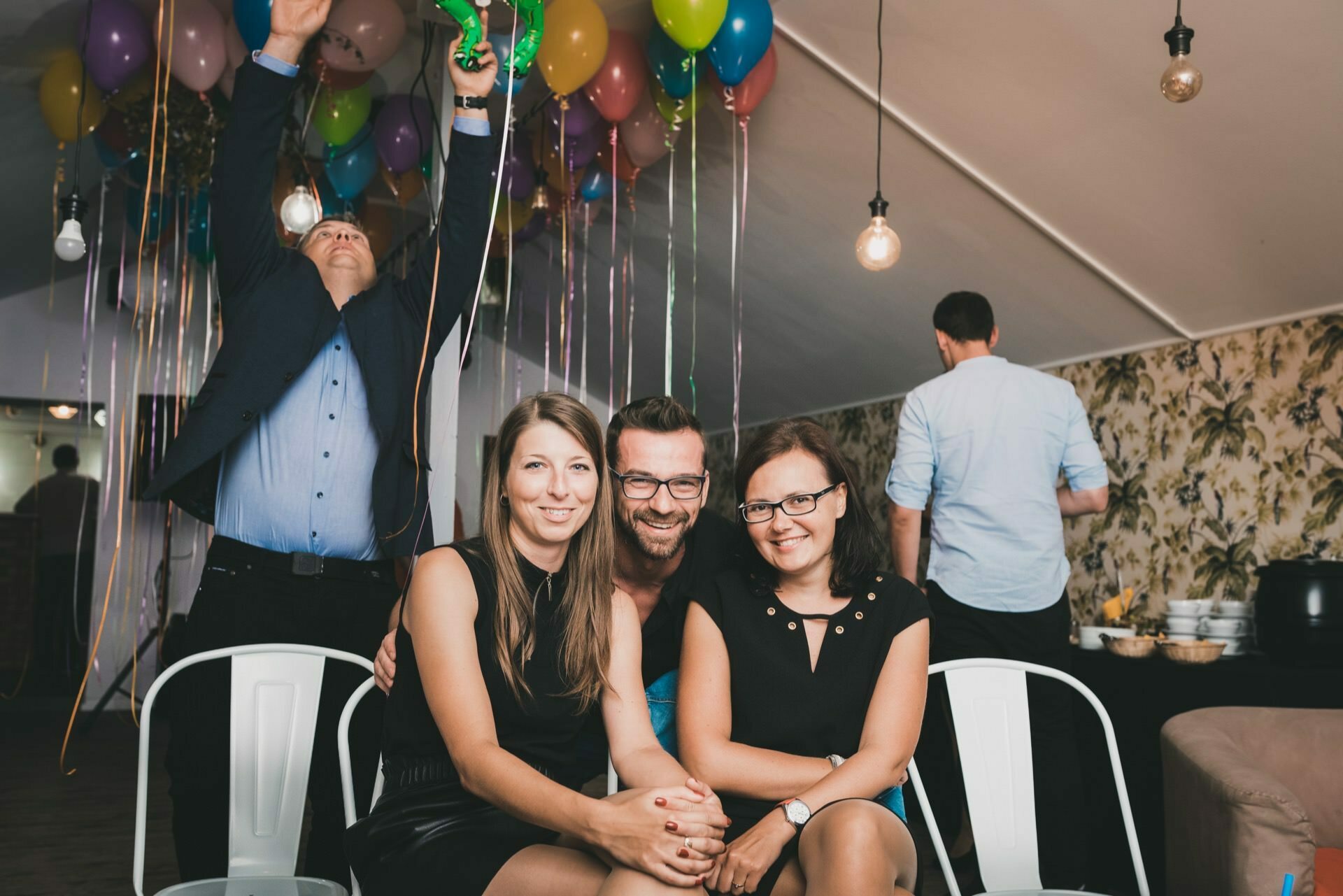 Man with bearded glasses poses with two girls