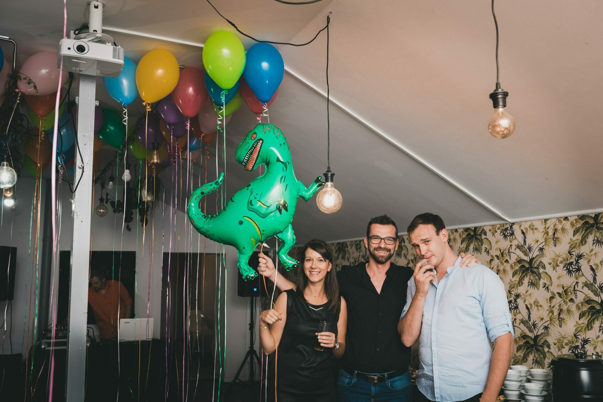 Girl holds birthday balloon and poses with birthday boy at birthday party