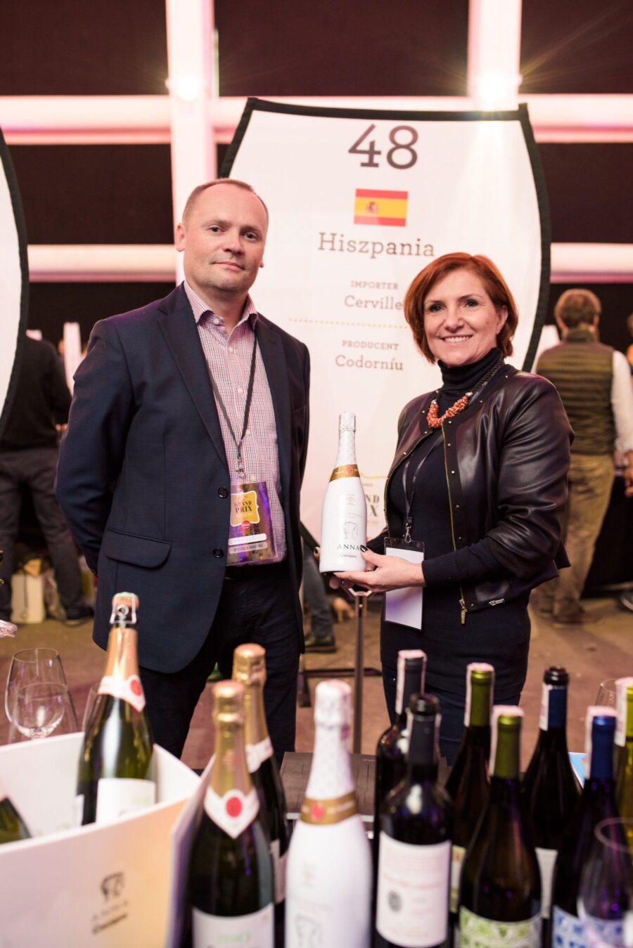 A woman and a man at a champagne stand