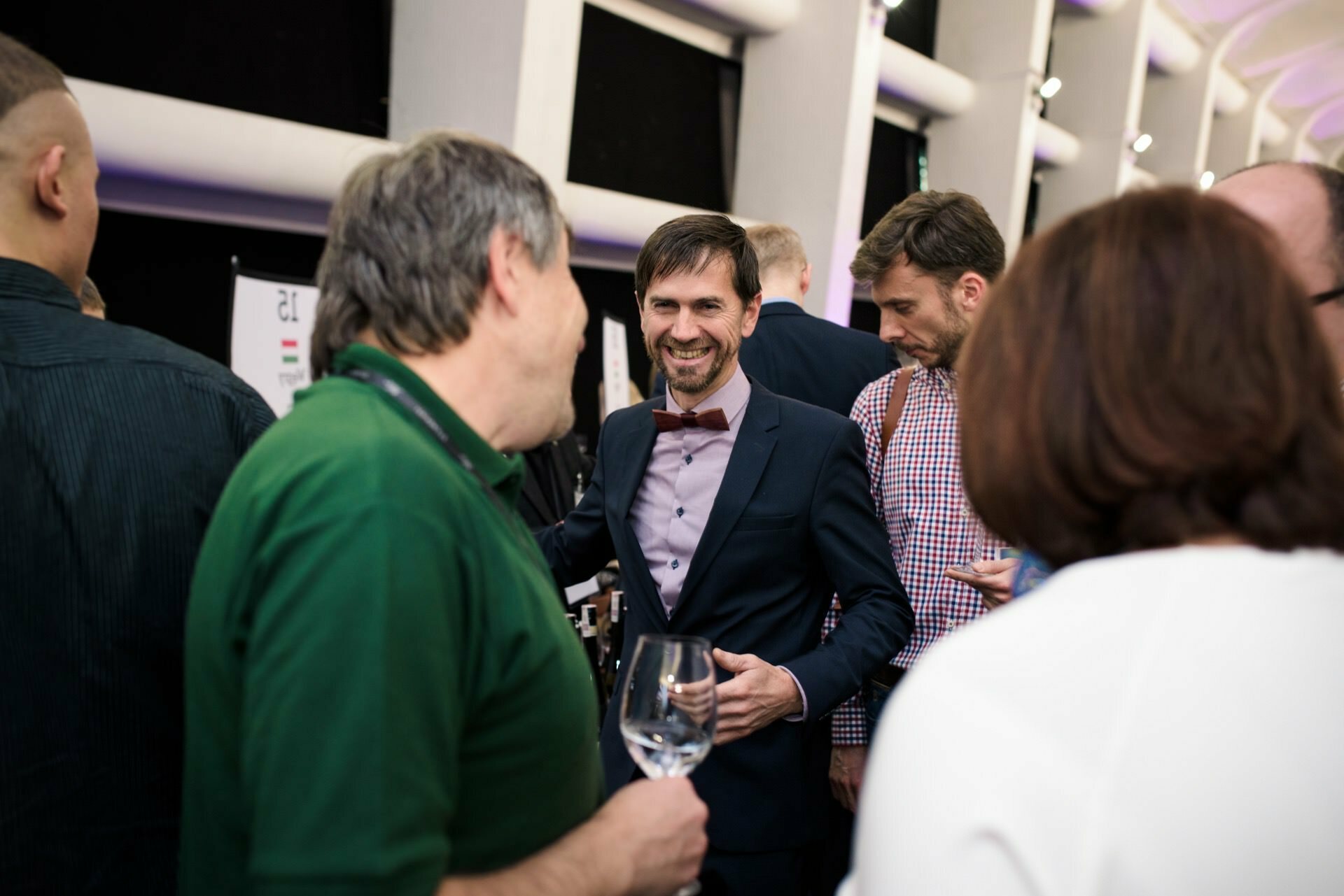 smiling man in shirt with bow tie at wine fair