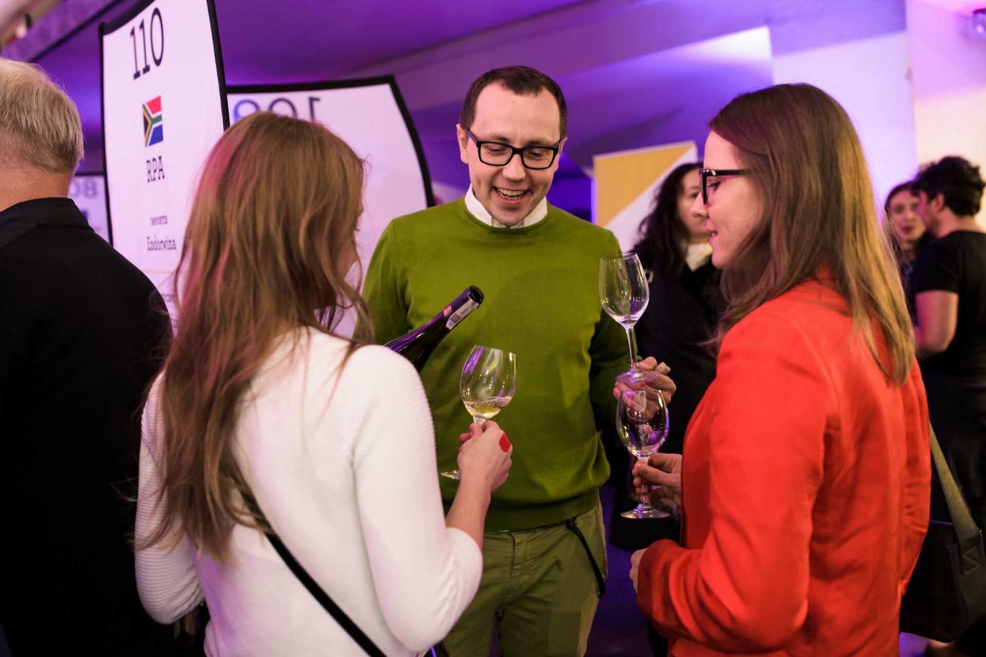 Happy people with glasses of wine in their hands