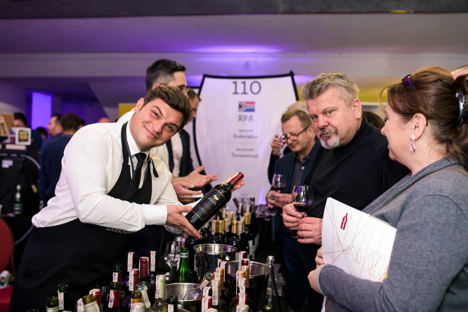 a happy and sad gentleman at a wine stand