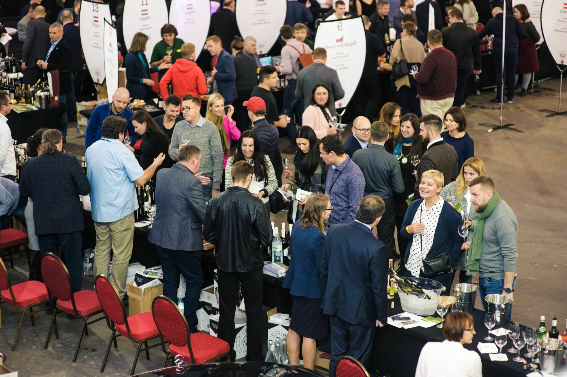 Crowds of people at booths during wine fair