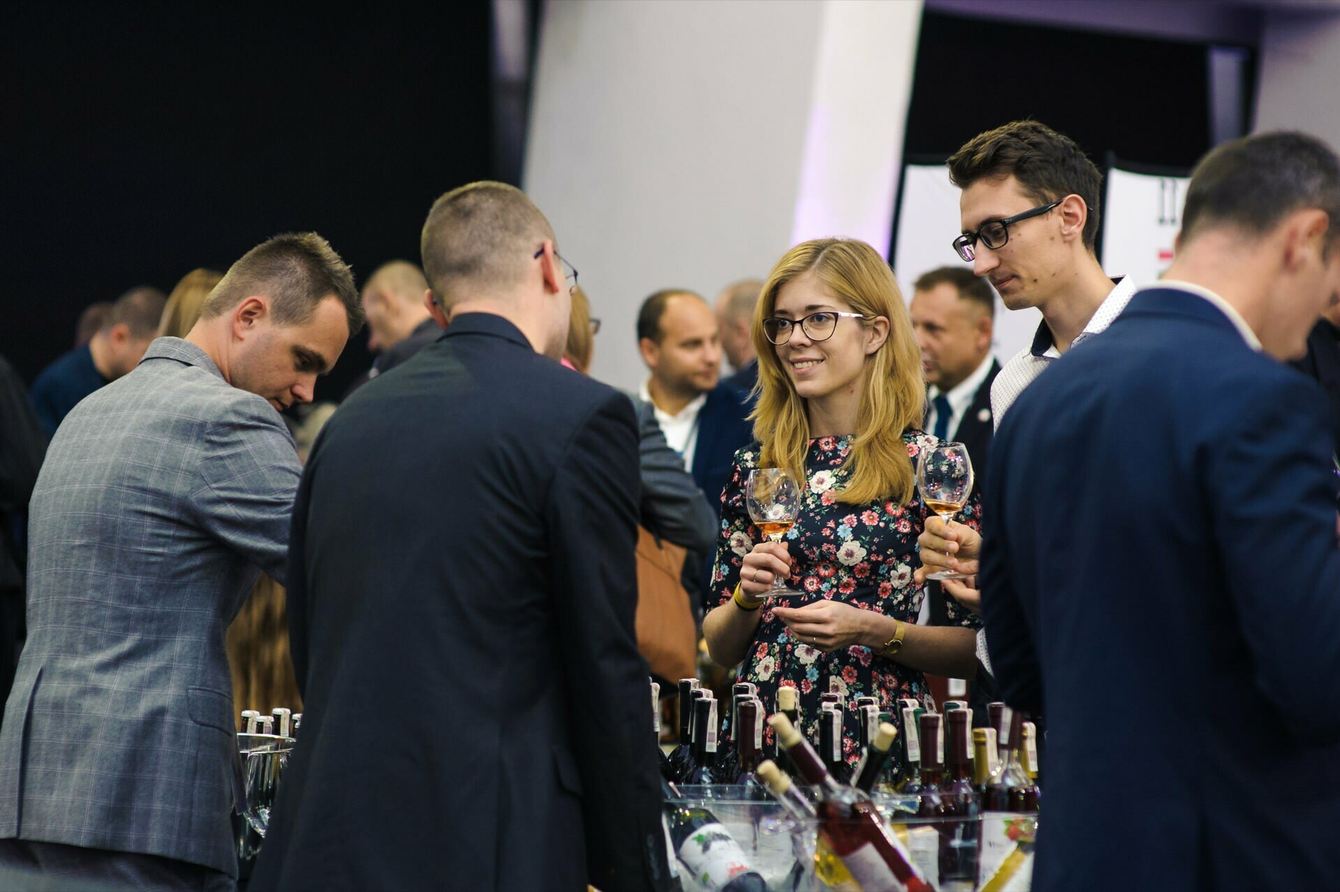 Girl with glasses holds wine glass at fair