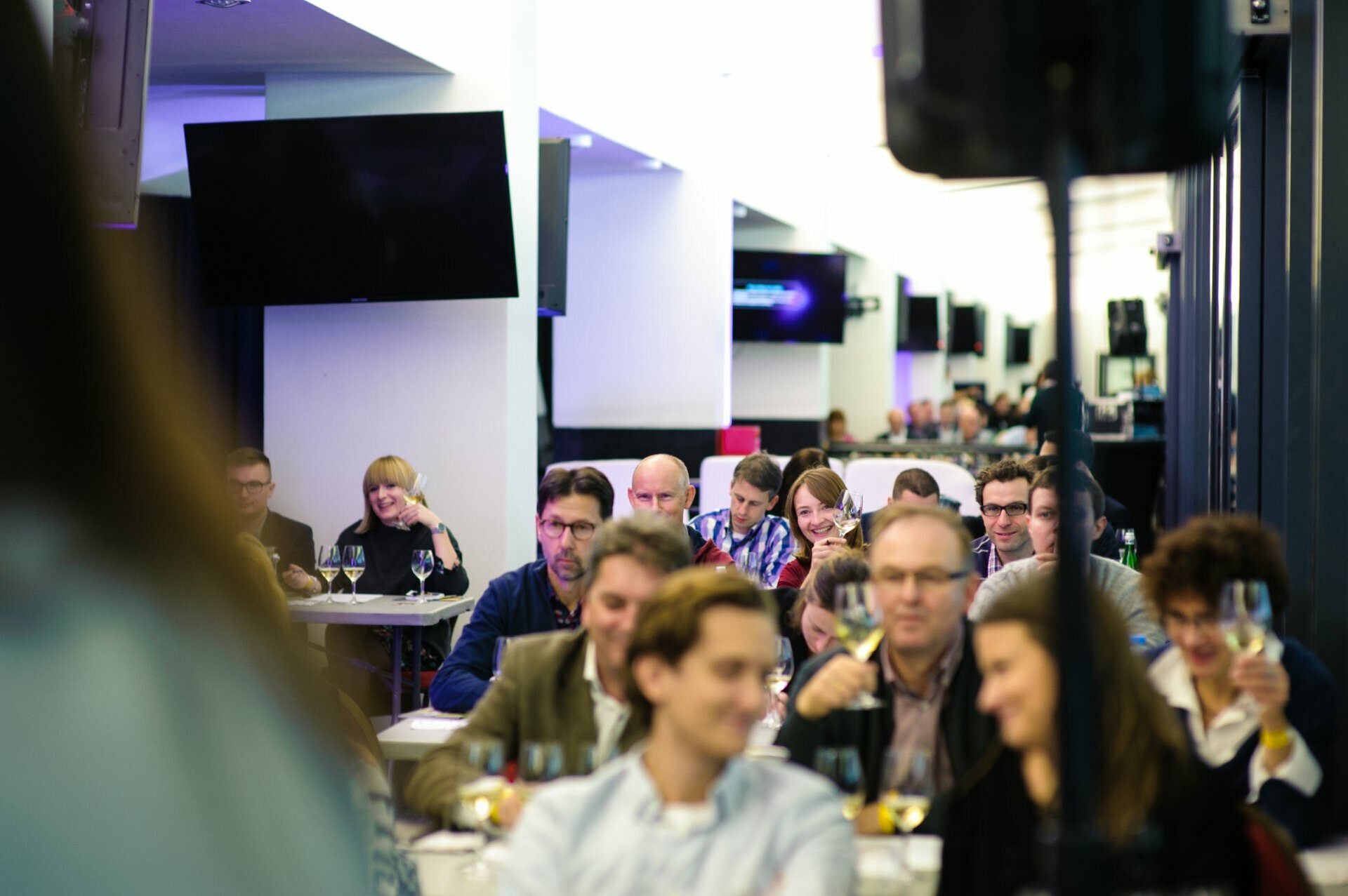 Full room of people testing wines