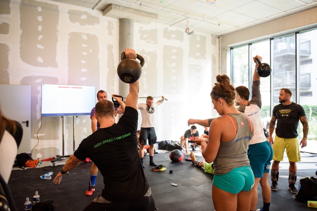 Athletes lifting kettlebells before a crossfit competition