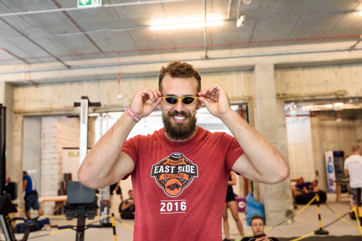 Guy in red shirt puts on tiny glasses