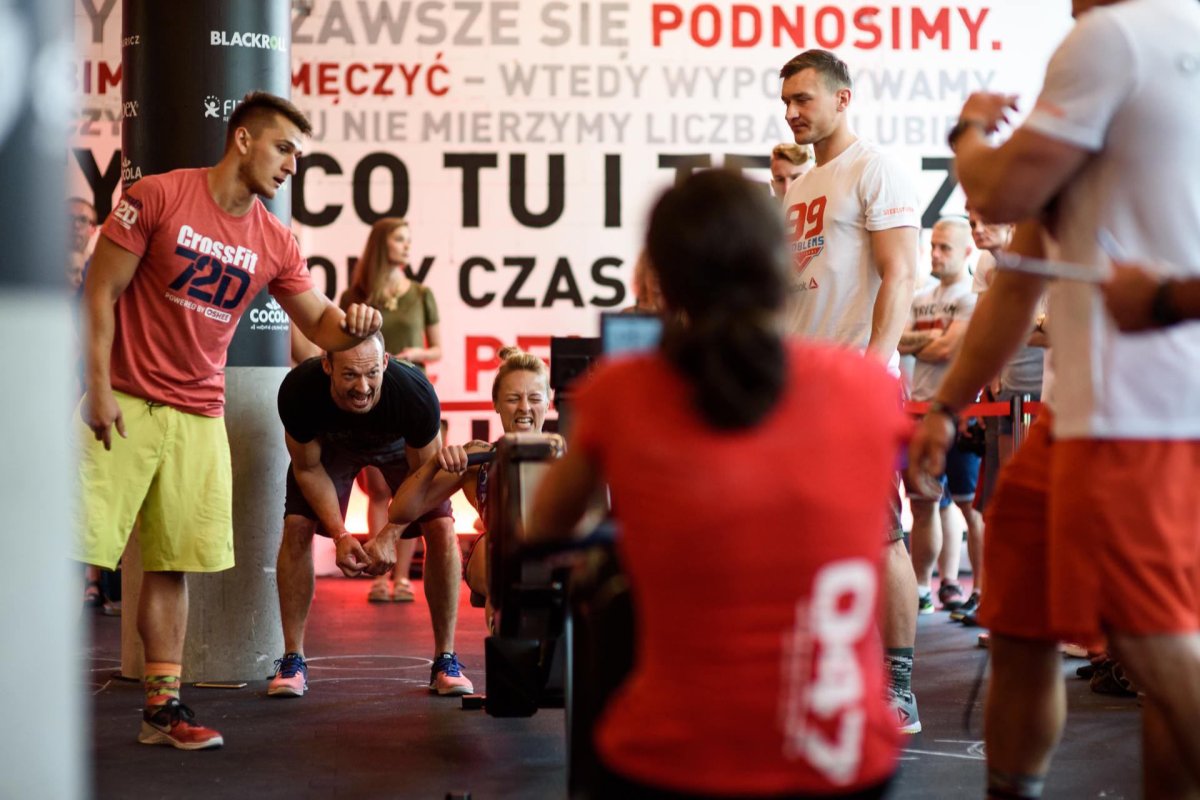 Girl rowing on machine during crossfit competition