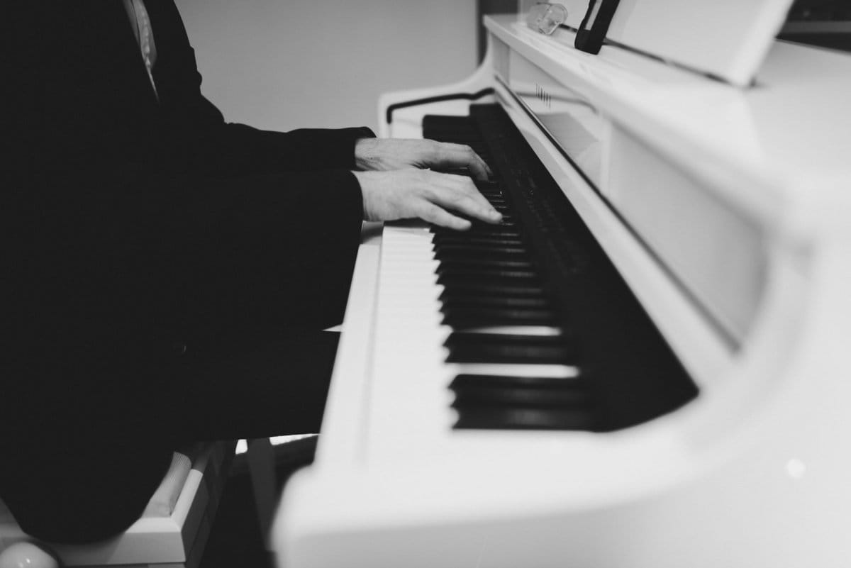 Hands of a man playing the piano