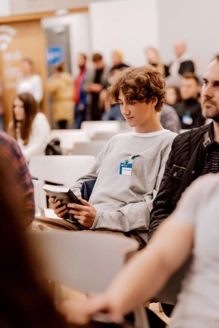 Conference participant holds a book as a reward for activity