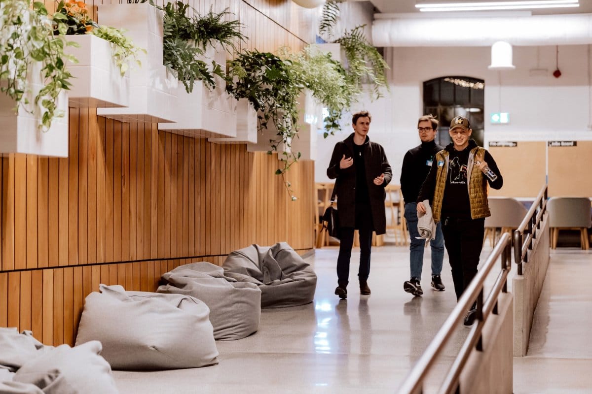 Three guys walking down a Google Campus corridor